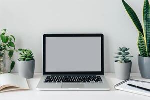Setup with Laptop Mockup and Open Notebook on White Desk Background photo