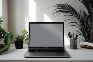 Open Notebook and Laptop Mockup on White Desk for   Writing and Work Setup photo