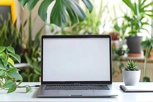 Work Setup with Laptop Mockup and Open Notebook on White Desk Background photo