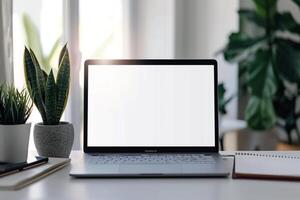 Laptop Mockup with Open Notebook and White Desk for   Writing and Work Setup photo