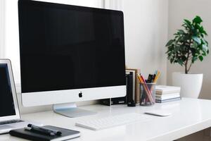 Computer Mockup on White Desk with Notebooks and Pens for Writing and Editing photo