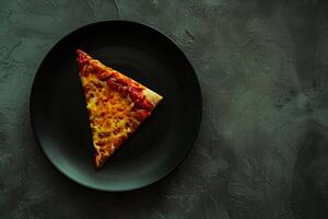 Single slice of pizza with toppings textured plate background photo