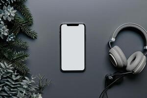 Mobile phone mockup screen with headphones on a slate  ed background photo