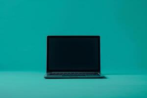 Laptop Mockup Against Teal Background for E Learning and Online Course Platforms photo