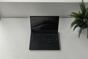 Overhead   of a Laptop Mockup Background on White Desk photo