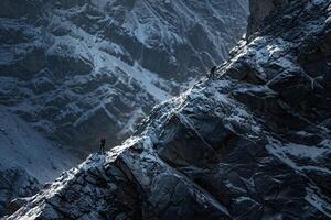 Climbers Scaling a Steep Rock Face in the Rugged Himalayan Mountains with a Challenging Ascent photo