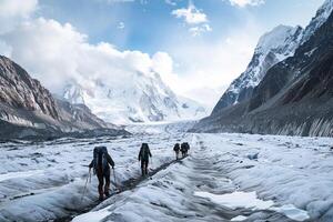 Mountaineers Traversing a Glacier with Towering Peaks in a Scenic Alpine Landscape photo