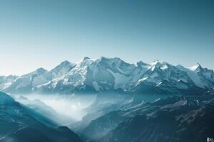 Snow Capped Peaks of the Swiss Alps with a   and Expansive Blue Sky photo