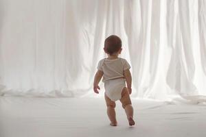 Baby Taking First Steps Exploring New Horizons with Excitement and Curiosity photo