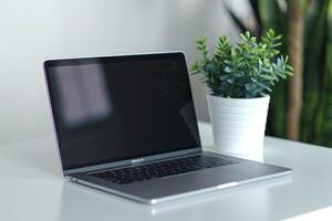 Laptop Mockup Screen on White Table for Business Use photo