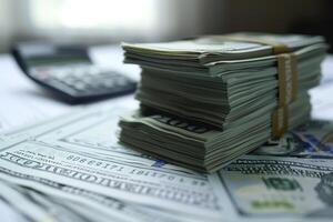 Stack of Hundred Dollar Bills with Calculator and Financial Report photo