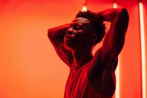 Man in Sportswear with Intense Red Background photo