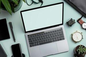 Laptop mockup screen on high tech desk with smartwatch and gadgets photo