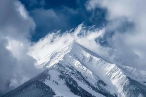 Snow Capped Mountain Peak in a Dramatic Cloudy Sky with a Majestic and Scenic Winter  Background photo