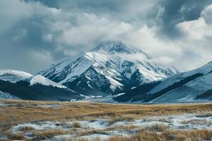 Snow Capped Mountain Peak at Dawn with Mist and Scenic Winter Landscape Highlighting the Majestic Horizon photo