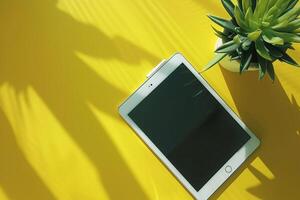 Tablet Screen Mockup with Lime Green Studio Potted Plant and   Vibe photo