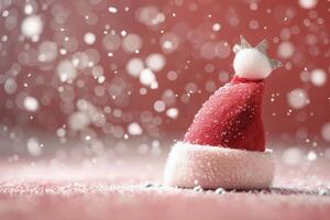 Christmas Santa Hat on Glittery Surface Surrounded by Snowflakes and Bokeh Lights photo