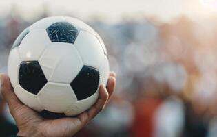 Soccer Player Holding Ball on Field photo
