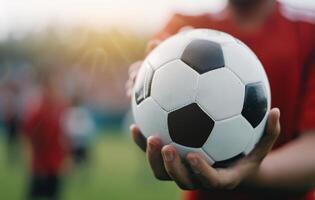Soccer Player Holding Ball on Field photo