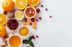 Citrus Fruits, Berries, and Honey on White Background photo