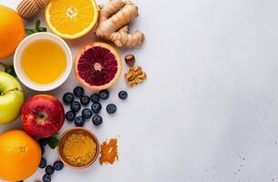Citrus Fruit, Honey, Ginger, and Blueberries on White Background photo
