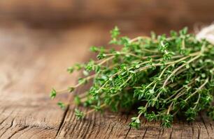 Fresh Thyme Sprigs on Wooden Table photo