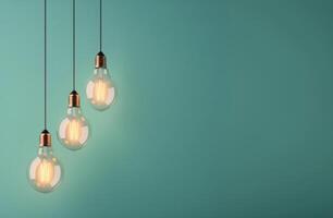 Single Lightbulb Hanging Against Teal Wall photo