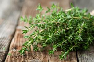 Fresh Thyme Sprigs on Wooden Table photo