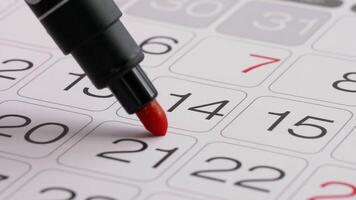 Valentine's day mark on a wall calendar. Drawing a red heart on 14th February with a felt-tip pen video