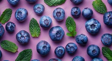 Blueberries and Mint on Purple Background photo