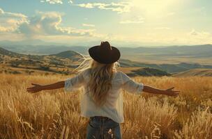 Woman in Hat Stands in Field photo