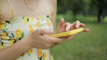 Close up of woman user holding cell phone using apps looking at smartphone texting messages standing outside. Mobile online applications concept. video