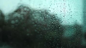 Window with condensate or steam after heavy rain, large texture or background. Wood table top on rain drops on clear window video
