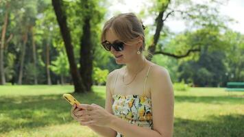 Close up of woman user holding cell phone using apps looking at smartphone texting messages standing outside. Mobile online applications concept. video