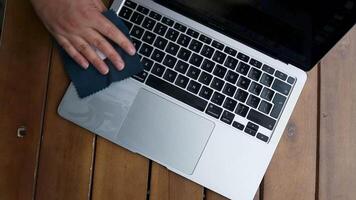 Laptop cleaning up. Service for cleaning notebook screen, keyboard, case. Cleaning accessories. brush, cloth, spray. Computer monitor, display care. Professional service, clean up. Man who wipe laptop video