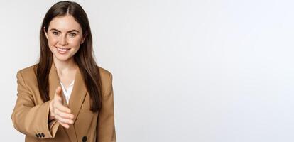 Portrait of smiling businesswoman extend hand for handshake, greeting business partner, saleswoman welcome client, white background photo