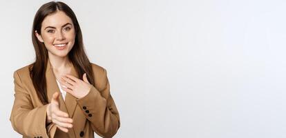 Portrait of smiling businesswoman extend hand for handshake, greeting business partner, saleswoman welcome client, white background photo