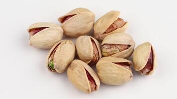 Delicious pistachios nuts on a white background video