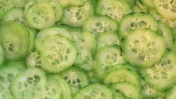 Many cucumbers are thinly sliced. video
