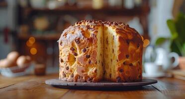 A Sliced Panettone Cake on a Silver Cake Stand in a Bakery Setting photo