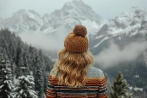 Woman Admires Snowy Mountain Range in Winter photo