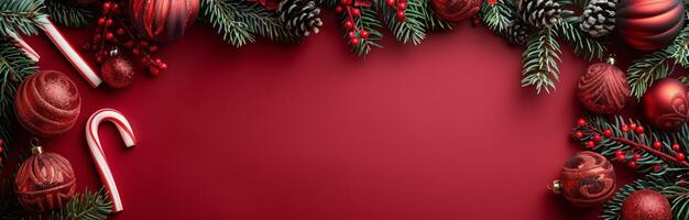 Red Christmas Background With Pine Branches, Ornaments, and Candy Canes photo