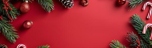 Red Christmas Background With Pine Branches, Ornaments, and Candy Canes photo