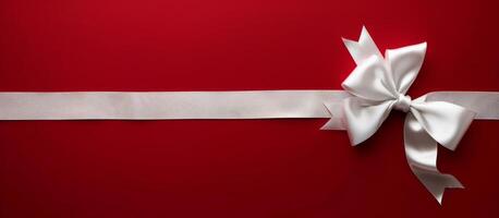White Satin Bow on Red Background With Silver Ribbon photo