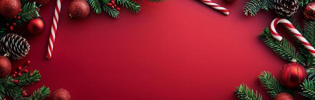 Red Christmas Background With Pine Branches, Ornaments, and Candy Canes photo