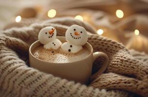 Two Snowman Marshmallows in a Mug of Hot Chocolate on a Cozy Winter Bed photo