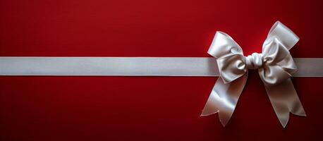 White Satin Bow on Red Background With Silver Ribbon photo