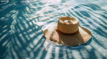 Straw Hat Floating in a Pool of Blue Water With Palm Tree Shadows photo