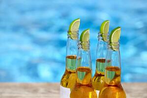 Closeup view of beer bottles and lime slices photo