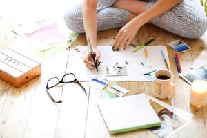 Young brunette woman creating her Feng Shui wish map using scissors photo